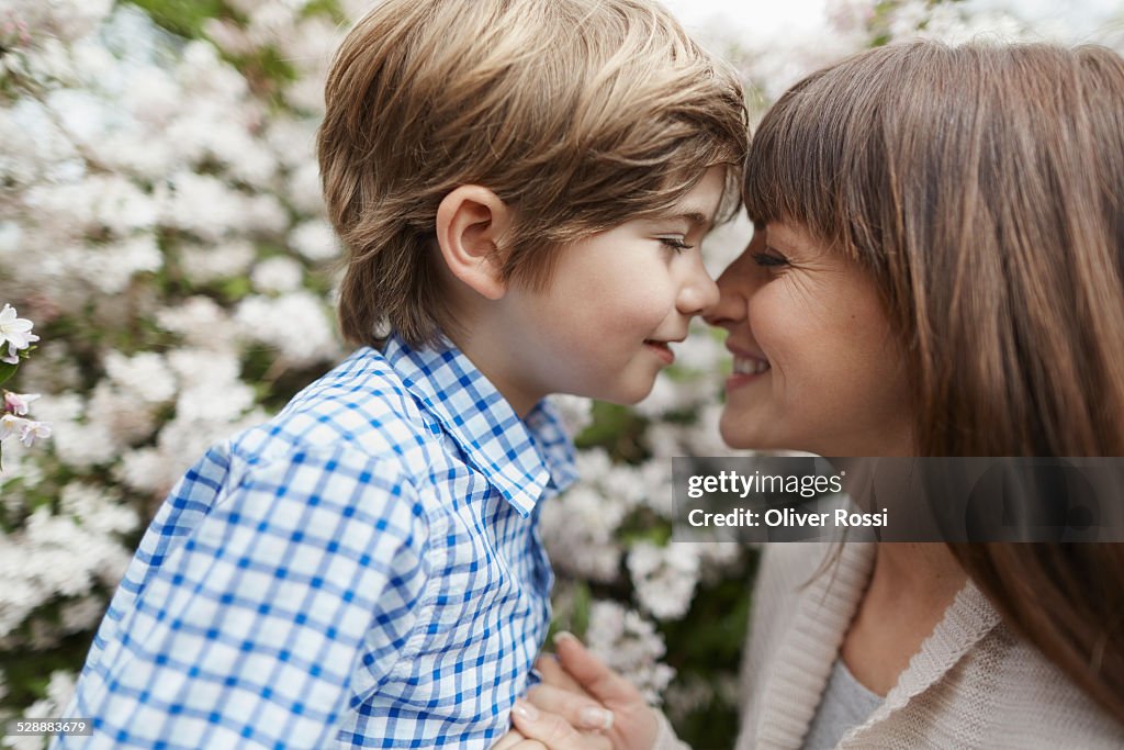 Smiling mother with son outdoors