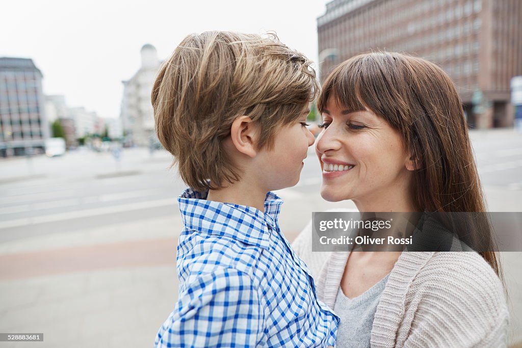 Smiling mother with son outdoors