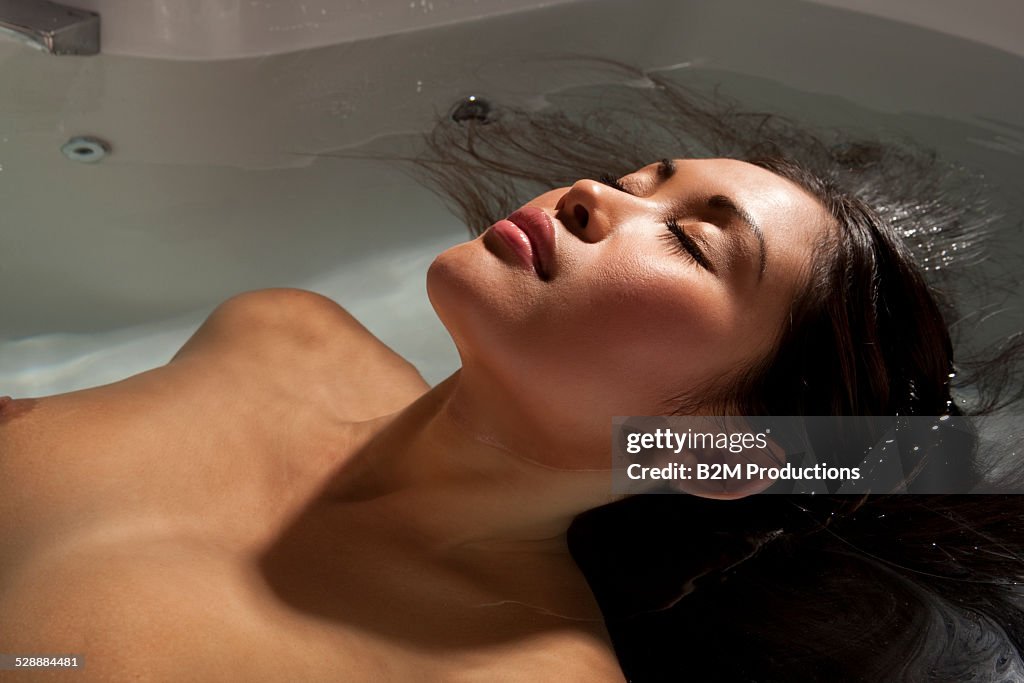 Woman relaxing in bathtub