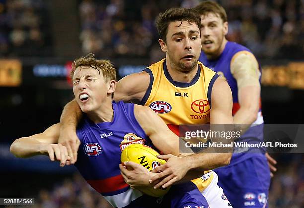 Bailey Dale of the Bulldogs is tackled by Rory Atkins of the Crows during the 2016 AFL Round 07 match between the Western Bulldogs and the Adelaide...