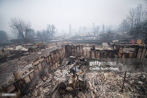 Home foundations and skeletons of possesions are all that remain in parts of a residential neighborhood destroyed by a wildfire on May 7, 2016 in...