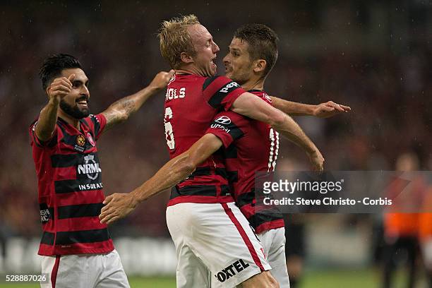 Dario Vidosic of the Wanderers celebrates scoring with teammate Mitch Nichols and Dimas Delgado during the round 20 A-League match between Sydney FC...