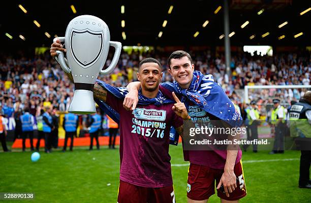 Andre Gray of Burnley and Michael Keane of Burnley celebrate winning the Championship after the Sky Bet Championship between Charlton Athletic and...