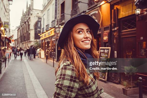 attractive woman sightseeing in paris - paris street woman stock pictures, royalty-free photos & images