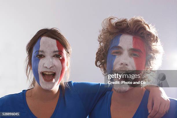 french couple fan with painted face - face paint soccer stock pictures, royalty-free photos & images