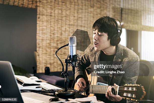 asia man singing - professional musician stock pictures, royalty-free photos & images