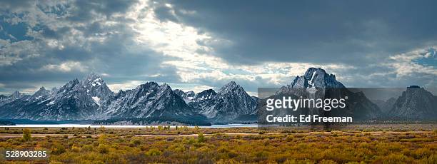 grand tetons in dramatic light - panoramic stock pictures, royalty-free photos & images