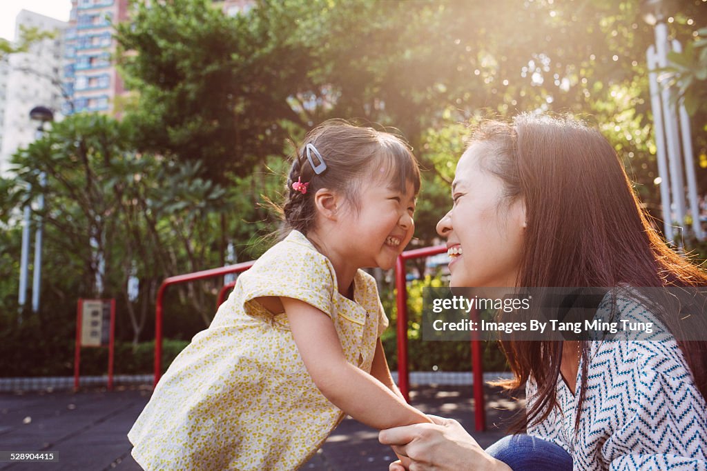 Mom & toddler playing joyfully in park