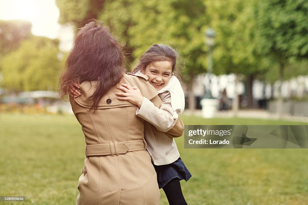 Brünette Mutter Tochter Umarmen im Park von Paris auf den Frühling am Nachmittag