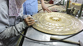 workers castigate bronze casting products, vietnam