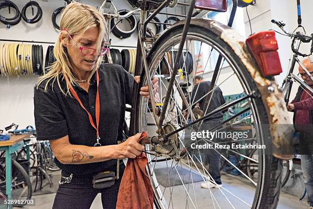 group repair bicycles - short sleeve work shirt stock pictures, royalty-free photos & images