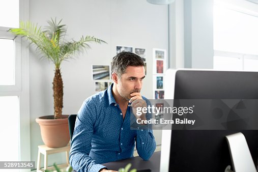 Office worker using a computer in creative space. Office worker using a computer in creative space.