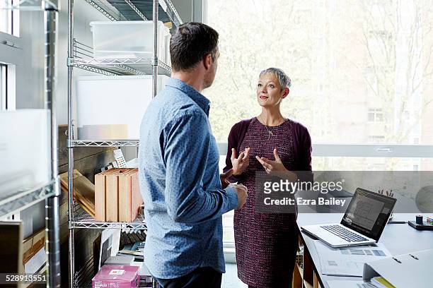 business colleagues discussing ideas in an office. - office shelf stock pictures, royalty-free photos & images