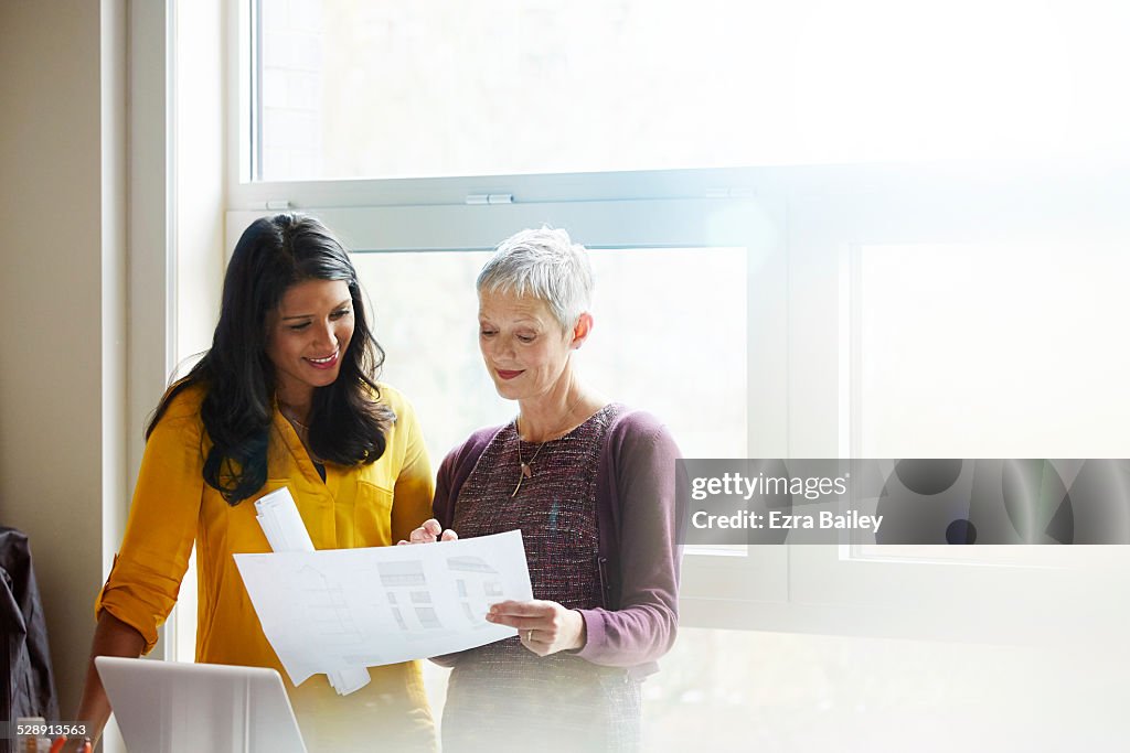 Business women discussing plans together.