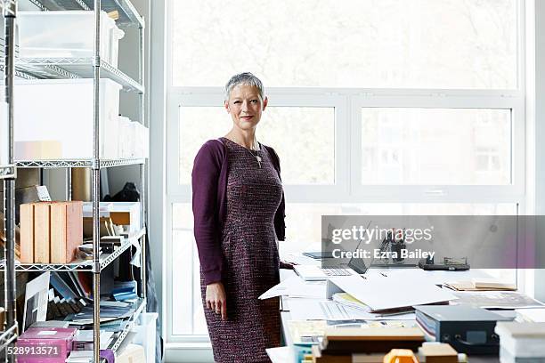 portrait of a business woman in creative office. - woman wearing purple dress stock pictures, royalty-free photos & images