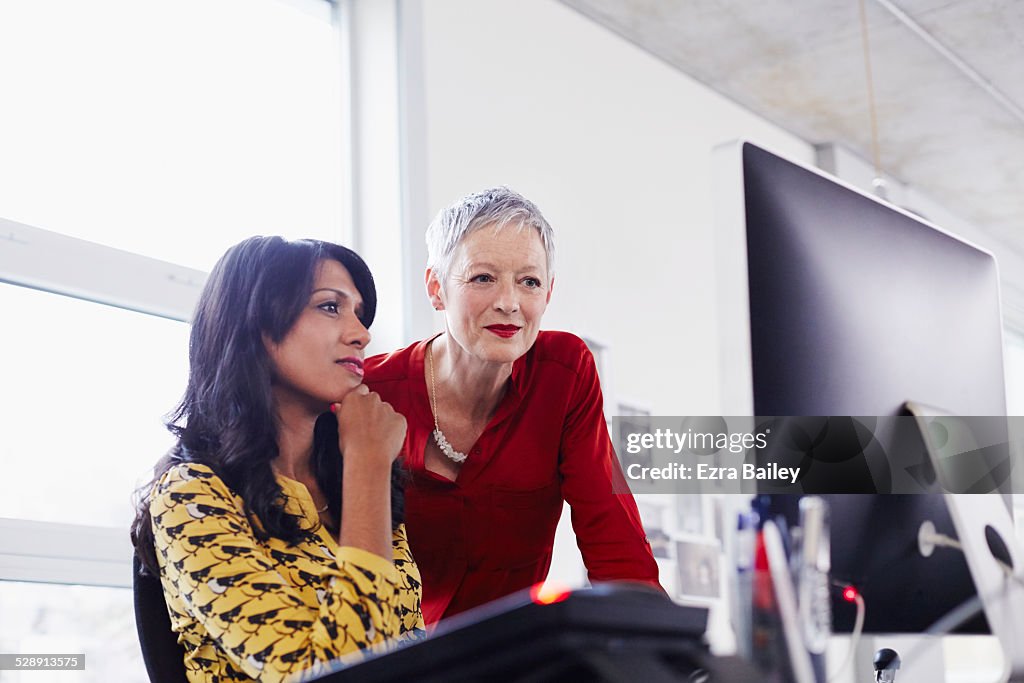 Mature business woman mentoring younger employee.