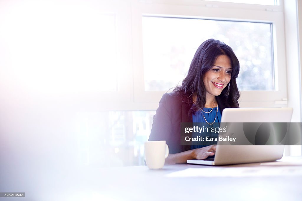 Young business woman working on a laptop.