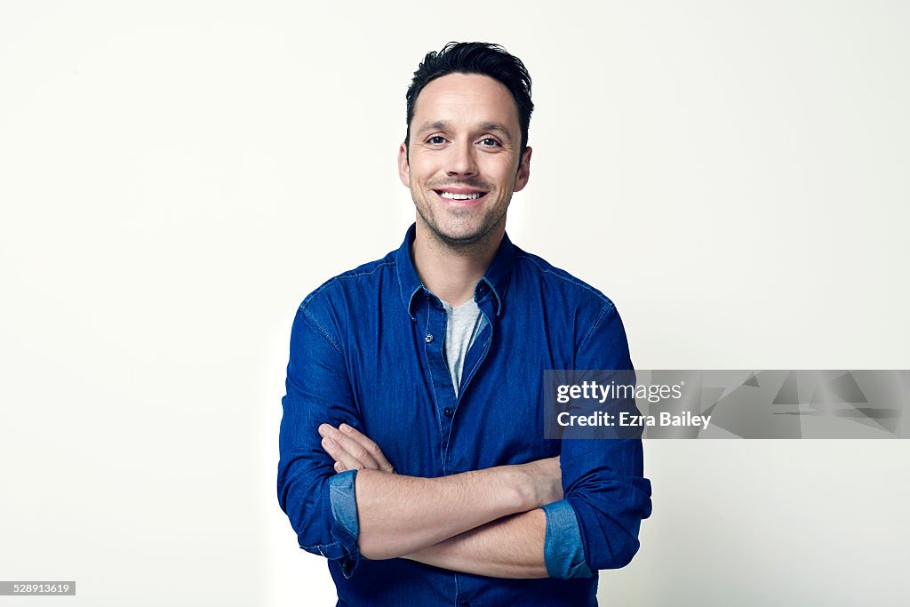 Portrait of a young guy with arms folded.