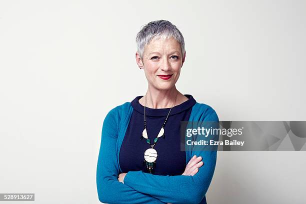 portrait of a business woman arms folded. - portrait white background confidence stock-fotos und bilder