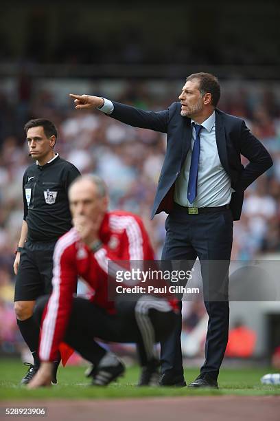 Manager Slaven Bilic of West Ham United shouts out from the touchline as manager Francesco Guidolin of Swansea looks on during the Barclays Premier...