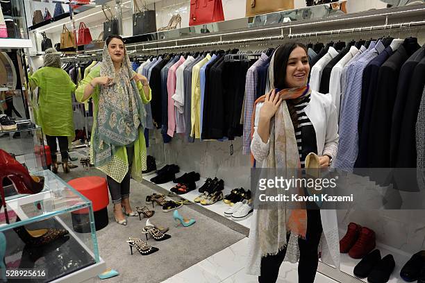 Young woman shops for famous international brand high heel shoes in the newly opened Palladium shopping mall on April 28, 2016 in Tehran, Iran....