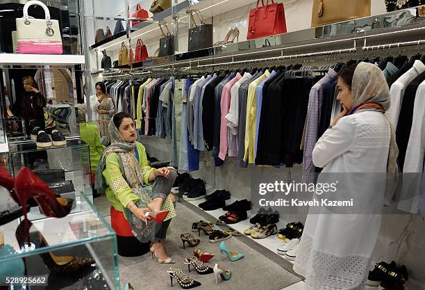 Young woman shops for famous international brand high heel shoes in the newly opened Palladium shopping mall on April 28, 2016 in Tehran, Iran....