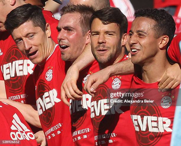 Robert Lewandowski, Philipp Lahm, Juan Bernat and Thiago of Bayern Muenchen celebrate their German Championship title after the Bundesliga match...