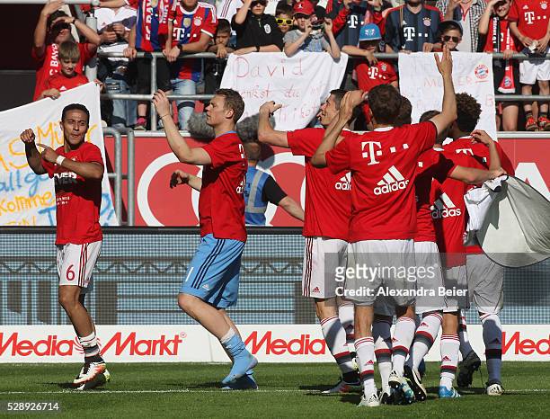Thiago, goalkeeeper Manuel Neuer, Robert Lewandowski and teammates of Bayern Muenchen celebrate their German Championship title after the Bundesliga...