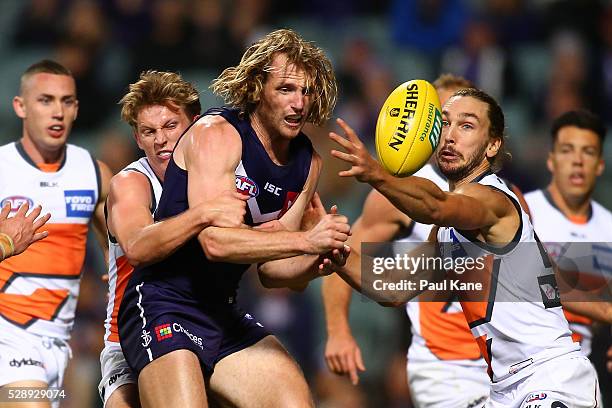 David Mundy of the Dockers gets his handball away while being tackled by Lachie Whitfield of the Giants during the round seven AFL match between the...