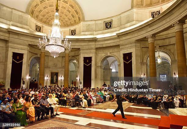 Defence officer walks to take Services Award from President Pranab Mukherjee during a Defence Investiture Ceremony at Rashtrapati Bhawan, on May 7,...