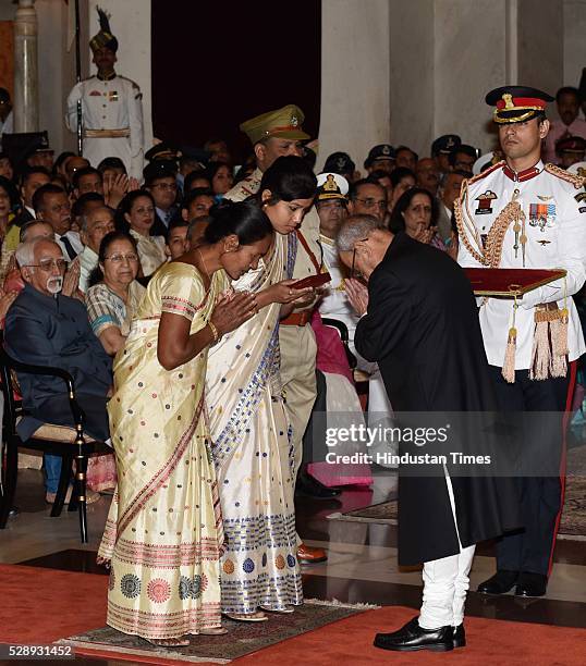 Mother and wife of Constable Gautam Koch of Assam Armed Branch receiving "Kirti Chakra" from President Pranab Mukherjee during a Defence Investiture...