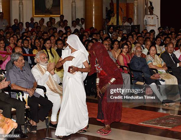 Mother and wife of Sepoy Dharma Ram of Mahar Regiment walk back after receiving Shaurya Chakra from President Pranab Mukherjee during a Defence...