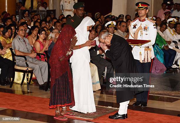 Mother and Wife of Sepoy Dharma Ram of Mahar Regiment stands to receive Shaurya Chakra" from President Pranab Mukherjee during a Defence Investiture...