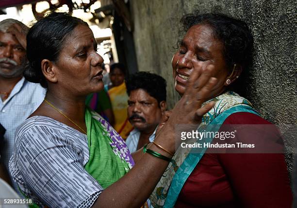 Woman consoles another as she breaks down after her room got burnt in a fire at a slum cluster of Gautam Nagar, Govandi on May 6, 2016 in Mumbai,...