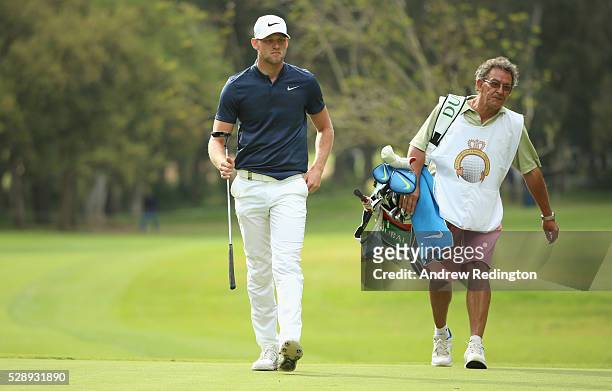 Joshua White of England walks with his caddie on the 18th hole during the third round of the Trophee Hassan II at Royal Golf Dar Es Salam on May 7,...