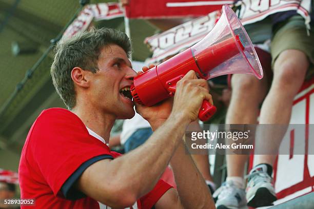 Thomas Mueller of Muenchen celebrates being Bundesliga champions with the fans after beating Ingolstadt 2-1 in the Bundesliga match between FC...