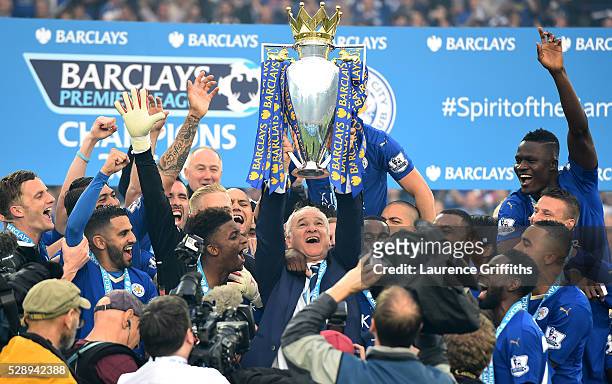 Claudio Ranieri Manager of Leicester City lifts the Premier League Trophy as players celebrate the season champions after the Barclays Premier League...