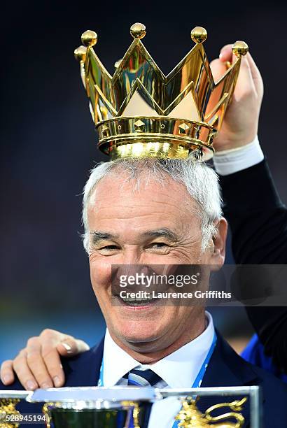 Claudio Ranieri Manager of Leicester City poses with the crown of the Premier League Trophy after the Barclays Premier League match between Leicester...