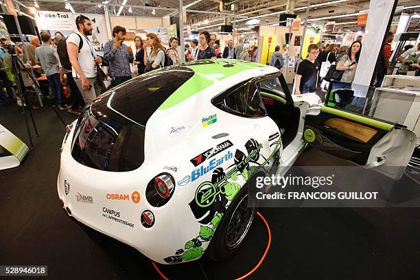 People look at the PGO E-Hemera, an electric car created by students of the Cevennes Car Club of the Ecole des mines d'Ales and winner of the third...