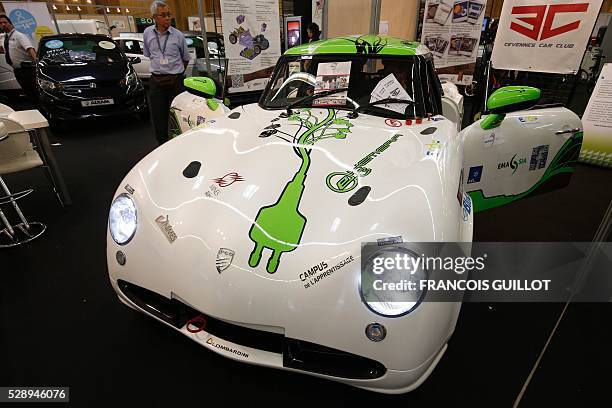 People look at the PGO E-Hemera, an electric car created by students of the Cevennes Car Club of the Ecole des mines d'Ales and winner of the third...