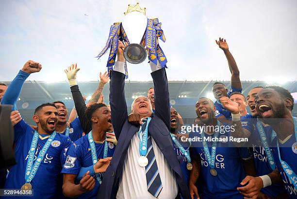 Claudio Ranieri Manager of Leicester City lifts the Premier League Trophy as players celebrate the season champions after the Barclays Premier League...