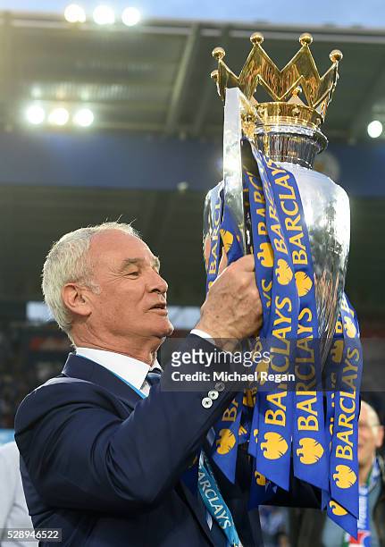 Claudio Ranieri lifts the Premier League Trophy as players and staffs celebrate the season champions after the Barclays Premier League match between...