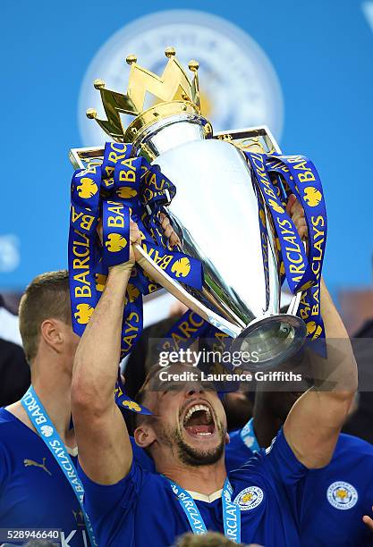 Danny Drinkwater of Leicester City lifts the Premier League Trophy as players and staffs celebrate the season champions after the Barclays Premier...