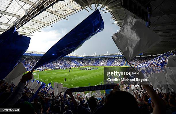 Leicester City supporters wave flags in celebration of the season champions after the Barclays Premier League match between Leicester City and...
