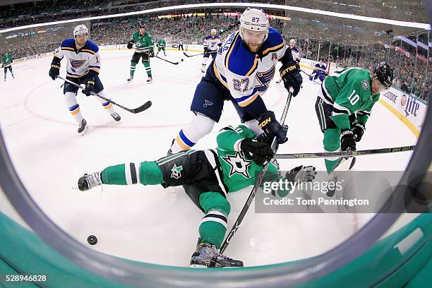 Alex Pietrangelo of the St. Louis Blues battles for control of the puck against Cody Eakin of the Dallas Stars and Patrick Sharp of the Dallas Stars...