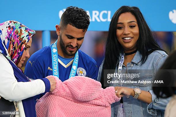 Riyad Mahrez of Leicester City holds daughter Inaya as wife Rita looks on, as Leicester City celebrate becoming Premier League Champions for the...