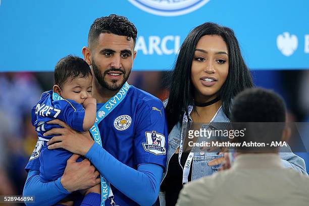 Riyad Mahrez of Leicester City holds daughter Inaya as wife Rita looks on, as Leicester City celebrate becoming Premier League Champions for the...
