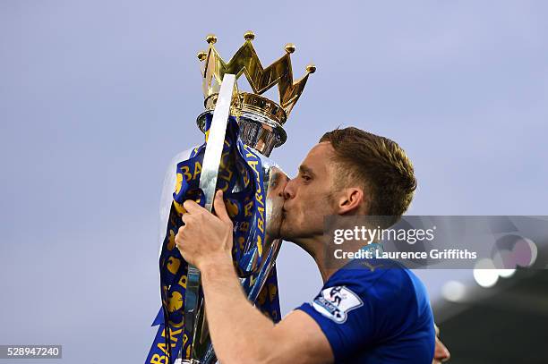 Andy King of Leicester City kisses the Premier League Trophy as players and staffs celebrate the season champions after the Barclays Premier League...