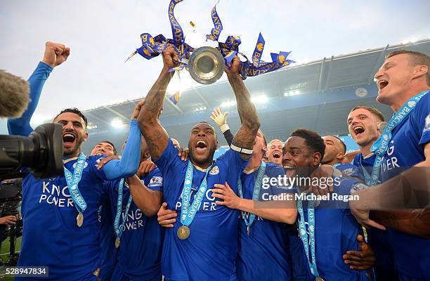 Captain Wes Morgan of Leicester City lifts the Premier League Trophy as players celebrate the season champions after the Barclays Premier League...