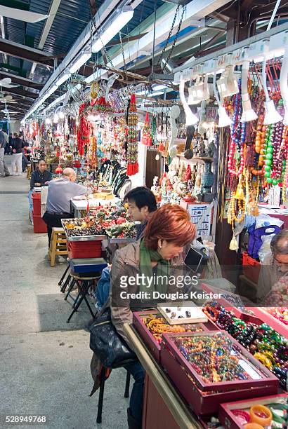 Vendors sell jewelry made from jade at the Jade Market in Hong Kong's Kowloon neighborhood.